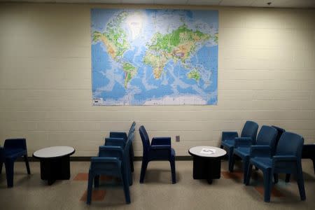 A world map is seen on the wall of the visiting area at the Adelanto immigration detention center, which is run by the Geo Group Inc (GEO.N), in Adelanto, California, U.S., April 13, 2017. REUTERS/Lucy Nicholson