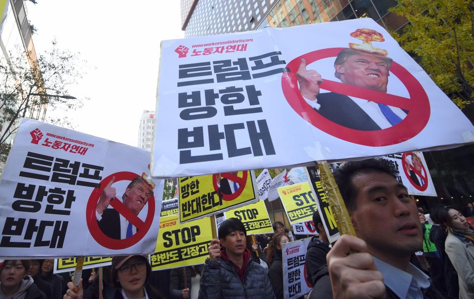 <p>South Korean protestors hold placards showing pictures of US President Donald Trump during an anti-Trump rally in Seoul on Nov. 4, 2017, ahead of Trump’s visit to South Korea. (Photo: Jung Yeon-Je/AFP/Getty Images) </p>