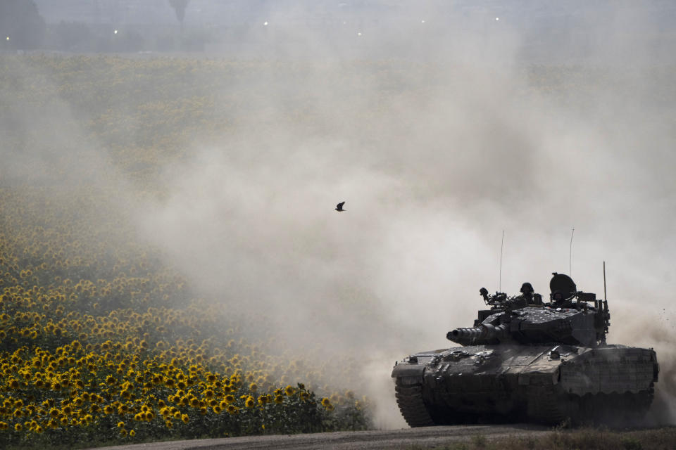 Israeli soldiers move on the top of a tank near the Israeli-Gaza border, as seen from southern Israel, Tuesday, May 28, 2024. (AP Photo/Leo Correa)