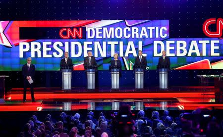 Moderator Anderson Cooper (L) stands onstage with Democratic U.S. presidential candidates (L-R) former U.S. Senator Jim Webb, U.S. Senator Bernie Sanders, former Secretary of State Hillary Clinton, former Maryland Governor Martin O'Malley and former Governor of Rhode Island Lincoln Chafee at the first official Democratic candidates debate of the 2016 presidential campaign in Las Vegas, Nevada October 13, 2015. REUTERS/Lucy Nicholson