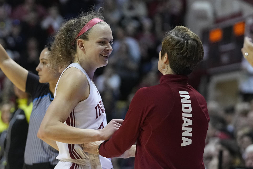 Indiana head coach Teri Moren talks, right, with Grace Berger after Berger was taken out of an NCAA college basketball game during the second half against Purdue, Sunday, Feb. 19, 2023, in Bloomington, Ind. (AP Photo/Darron Cummings)