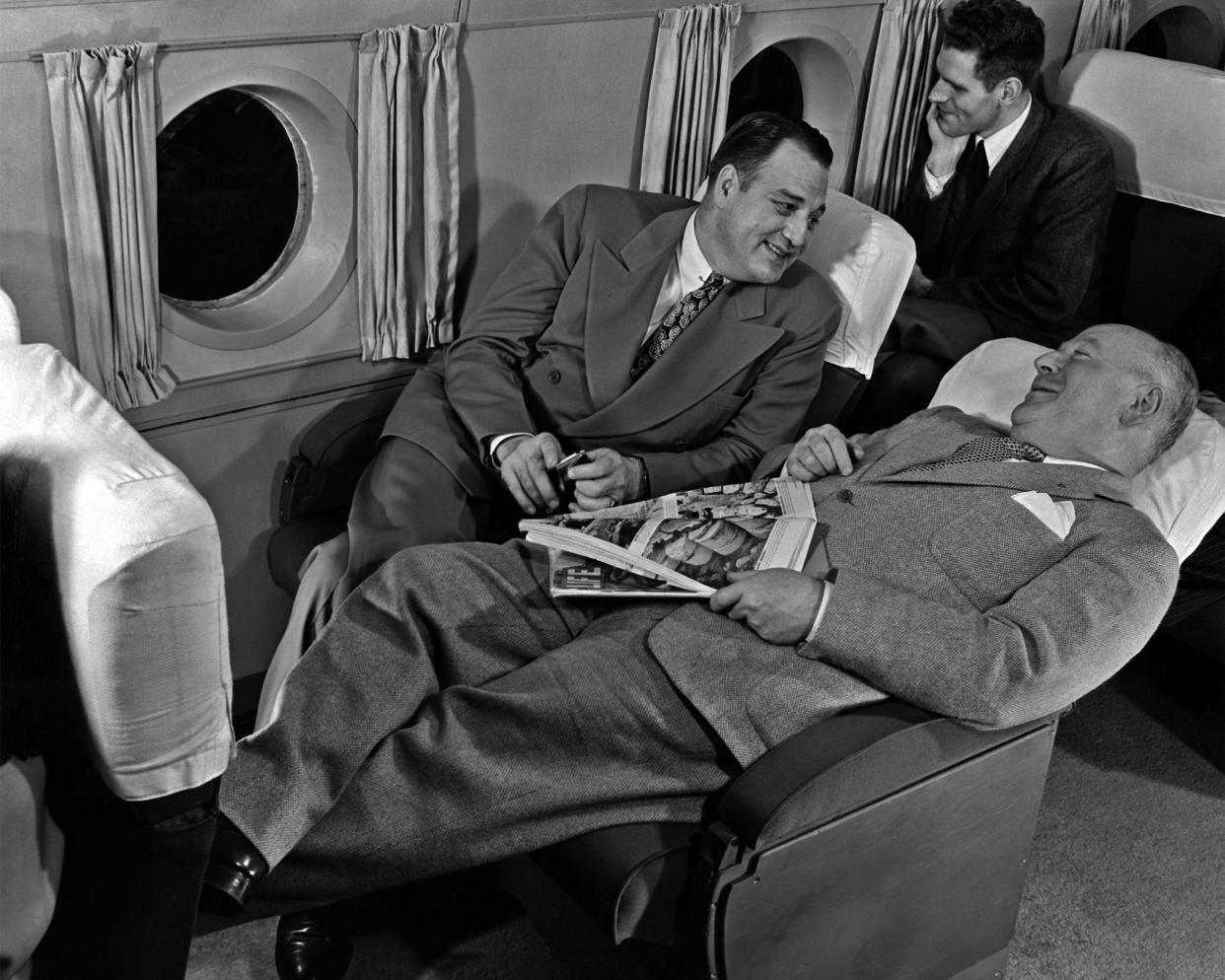 Passengers relaxing on an airline flight, circa 1950.