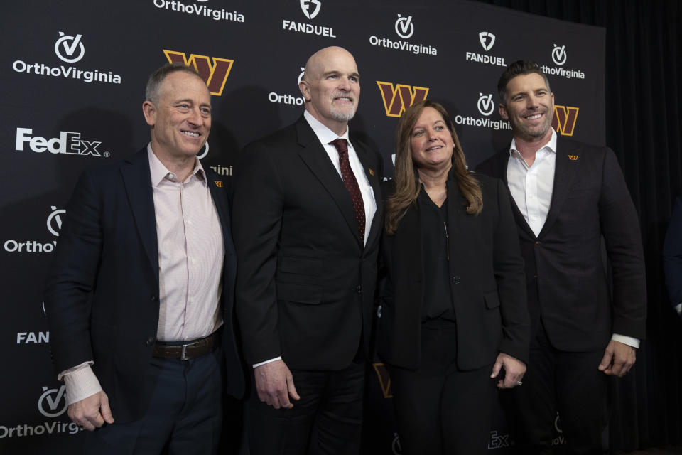Washington Commanders new head coach Dan Quinn, second from left, and his wife Stacey Quinn, second from right, pose for a photo with Commanders managing partner Josh Harris, left, and general manager Adam Peters, right, during an NFL football news conference at Commanders Park in Ashburn, Va., Monday, Feb. 5, 2024. (AP Photo/Manuel Balce Ceneta)