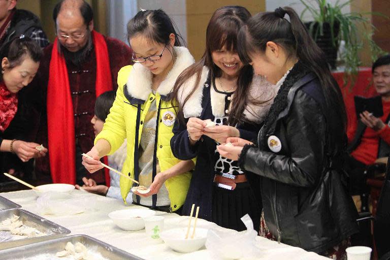 Migrant families gather to make dumplings as they prepare to celebrate the upcoming Lunar New Year, in Beijing, on January 28, 2014