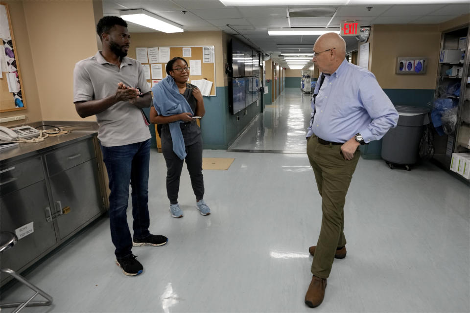 Dr. Marty Sellers, right, talks with Meharry Medical College students Emmanuel Kotey, left, and Teresa Belledent, center, after an organ procurement surgery June 15, 2023, in Jackson, Tenn. (AP Photo/Mark Humphrey)