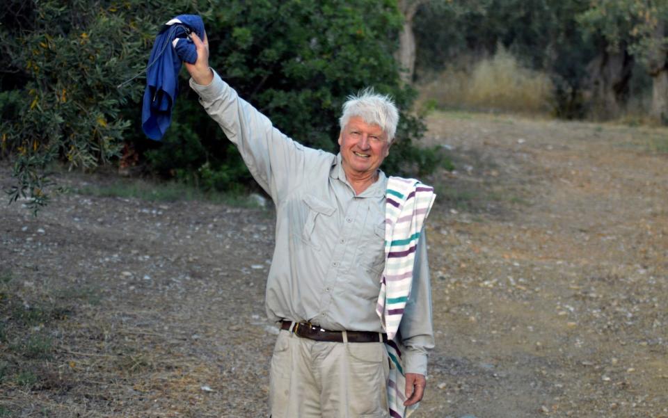 Stanley Johnson, father of Britain's Prime Minister Boris Johnson, waves to the local reporters outside his Villa Irene in Horto village, Mount Pelion -  Dimitris Kareklidis