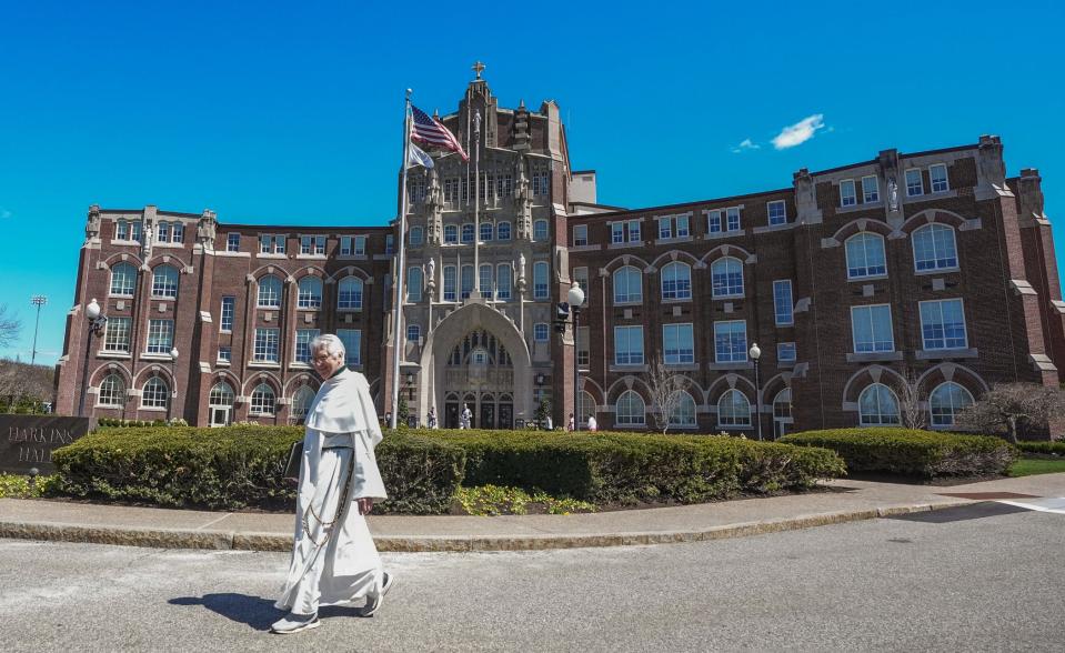 A staff member walks by Harkins Hall at Providence College, founded by the Dominican Order.