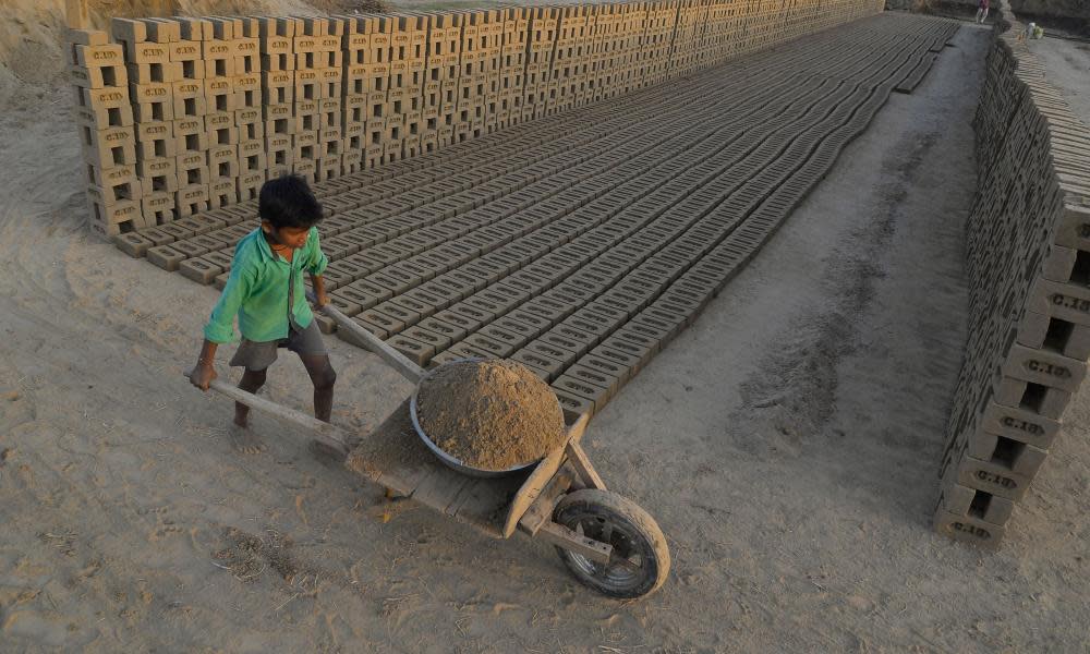 An Indian boy working at a brick kiln. Brick kiln workers in India are trapped in a cycle of bonded labour and regularly cheated out of promised wages, Anti-Slavery International said Wednesday, urging the government to safeguard their rights. 