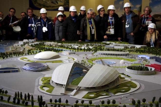 Journalists attend the presentation of a model of the Olympic Park on February 10, 2012, during a press trip at the Russian Black Sea resort of Sochi, venue of the 2014 Winter Olympics games. The Games will be the biggest international event hosted by Russia since the collapse of the Soviet Union but it faces the challenge of building much of the facilities from scratch in Sochi city and the surrounding mountains. Sochi will host the 2014 Winter Olympics which will start on February 7, 2014. (Photo by Fabrice Coffrini /AFP/Getty Images)