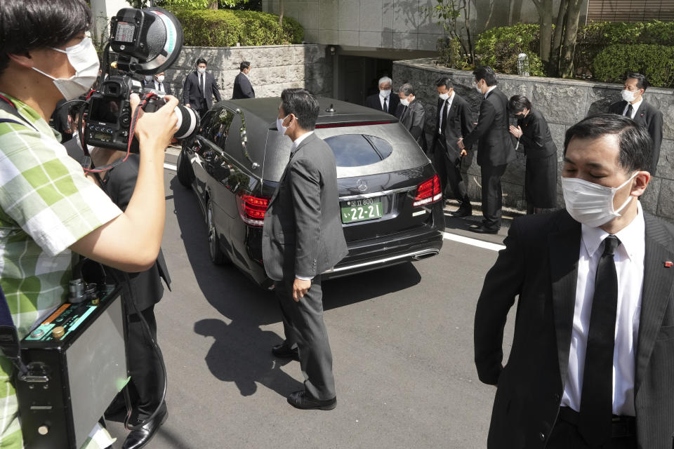 A car which is believed to carry the body of former Prime Minister Shinzo Abe, arrives at his home Saturday, July 9, 2022, in Tokyo. Former Prime Minister Shinzo Abe was assassinated on a street in western Japan by a gunman who opened fire on him from behind as he delivered a campaign speech Friday. (AP Photo/Eugene Hoshiko)