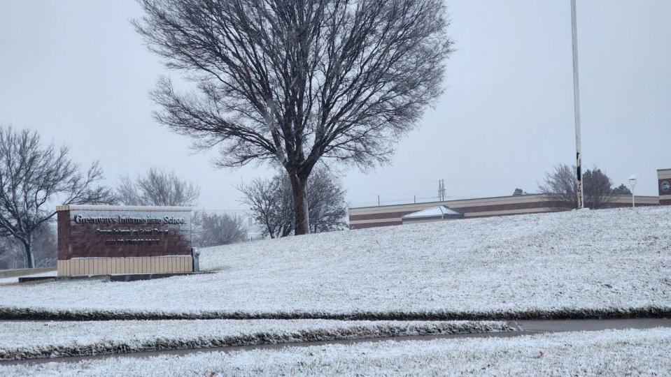 Snow falls in Amarillo on Thursday as a winter storm system passes through the area.