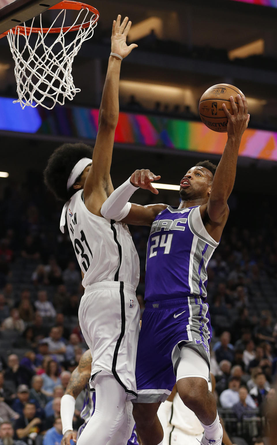 Sacramento Kings guard Buddy Hield, right, goes to the basket against Brooklyn Nets center Jarrett Allen, left, during the first quarter of an NBA basketball game Tuesday, March 19, 2019, in Sacramento, Calif. (AP Photo/Rich Pedroncelli)