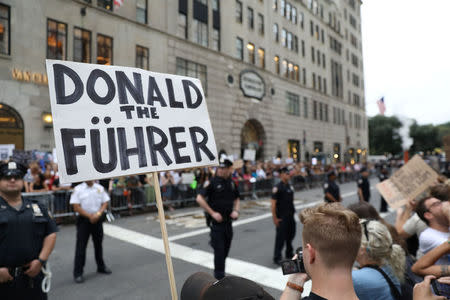 NYPD policemen stand guard as anti-Trump protesters gather in Manhattan in New York, U.S., August 14, 2017. REUTERS/Stephen Yang