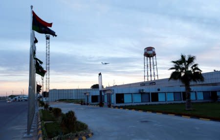 FILE PHOTO - A plane flies over Mitiga airport following clashes, in Tripoli, Libya, January 15, 2018. REUTERS/Ismail Zitouny