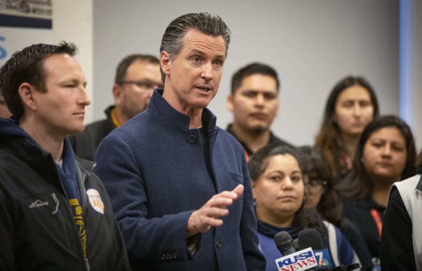 California Governor Gavin Newsom (D), center, holds a new conference at PATH San Diego's Connections Housing facility in downtown San Diego after the annual point-in-time homeless count, January 23, 2020 in San Diego, California.