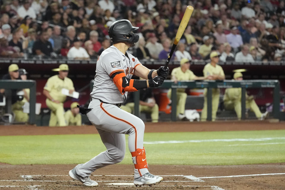 San Francisco Giants' Michael Conforto watches the flight of his three-run home run against the Arizona Diamondbacks during the third inning of a baseball game Tuesday, Sept. 24, 2024, in Phoenix. (AP Photo/Ross D. Franklin)