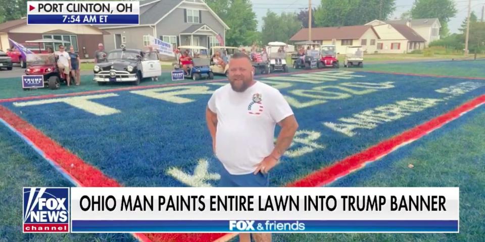 Ohio man JR Majewski stands on his Trump-themed lawn