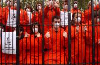 Amnesty International protestors demonstrate near Downing Street, London, over conditions for "enemy combatants" at the U.S. military detention centre in Guantanamo Bay, Cuba, during Prime Minister's Tony Blair's meeting with U.S. President George Bush November 20, 2003. (REUTERS/ David Bebber)