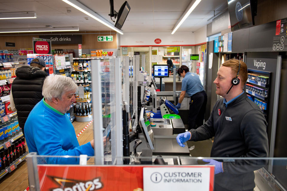 A clear screen divides employees and customers in store at a Co-op shop in Bromsgrove, Worcestershire. (Photo by Jacob King/PA Images via Getty Images)