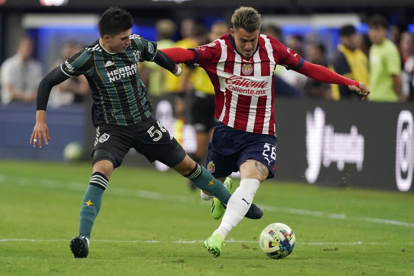 Los Angeles Galaxy forward Jonathan Perez, left, and Chivas defender Cristian Calderon battle for the ball during the second half of a Leagues Cup match Wednesday, Aug. 3, 2022, in Inglewood, Calif. (AP Photo/Mark J. Terrill)