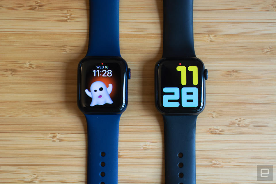 The Apple Watch Series 6 (left) next to the Apple Watch Series 5 (right) on a wooden table.