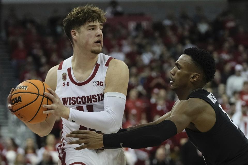 Wisconsin's Max Klesmit looks to pass around Michigan State's Tyson Walker during the second half of an NCAA college basketball game Tuesday, Jan. 10, 2023, in Madison, Wis. (AP Photo/Morry Gash)