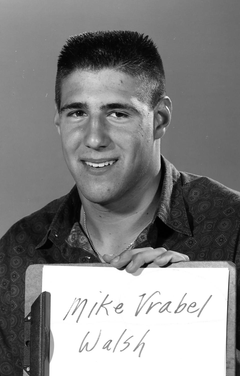 Walsh Jesuit High School graduate Mike Vrabel holds up a name tag as he poses for a portrait on June 3, 1992.