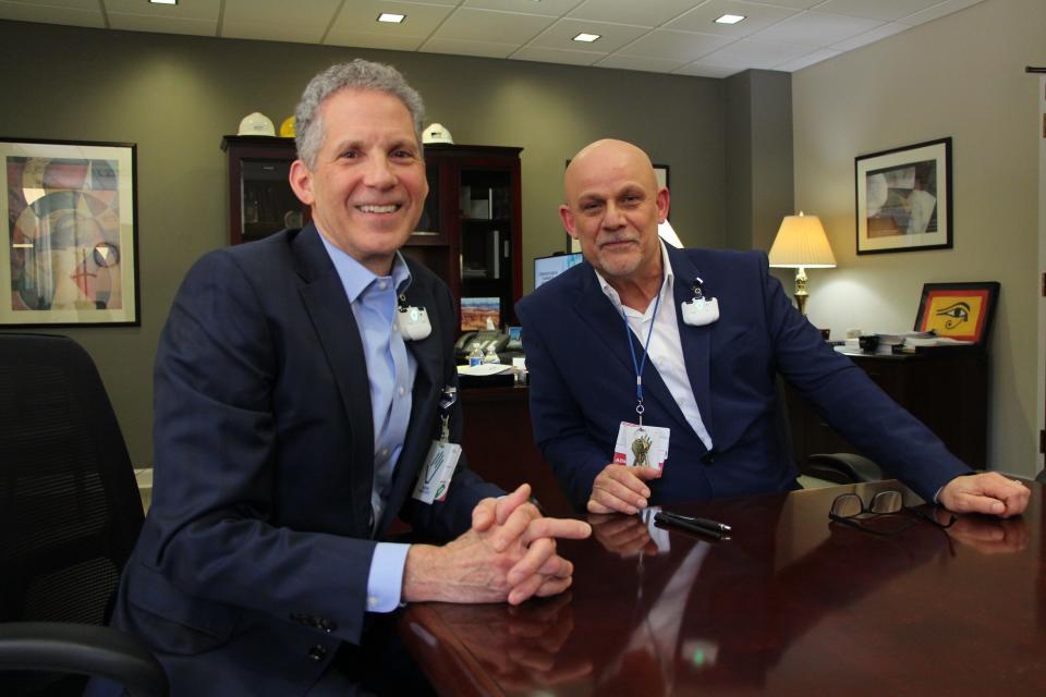 Charles Holland (left), president and CEO of St. Bernard Hospital in Chicago and Michael Richardson, the hospital's Patient Safety and Quality Officer, both wear devices on their lapels that register whether they've washed their hands before entering patient care spaces.