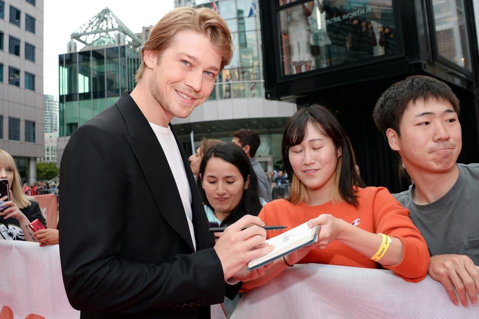 Joe Alwyn smiles while signing autographs ahead of the <em>Harriet</em> premiere during the Toronto International Film Festival on Tuesday.