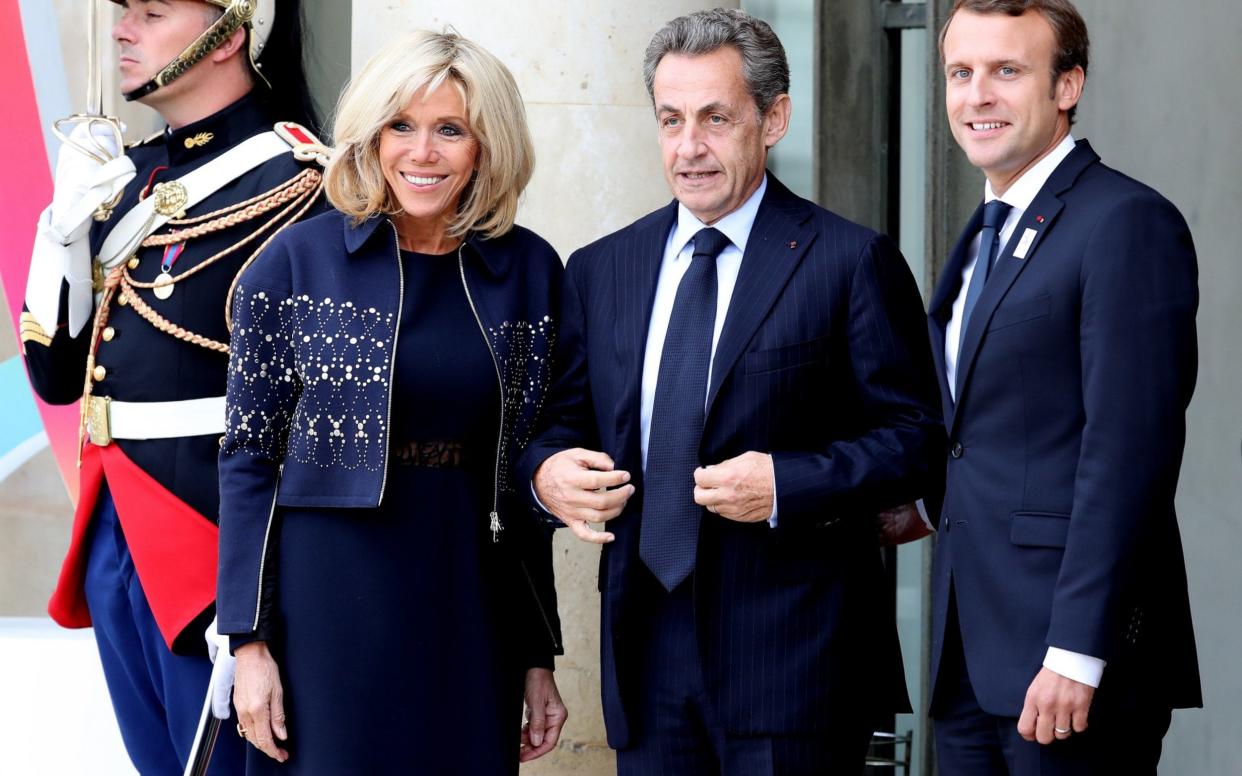 French President Emmanuel Macron (R) and his wife Brigitte (L) welcome former French President Nicolas Sarkozy (C) for Paris 2024 Olympic City reception at Elysee Palace in Paris, France on September 15 - Anadolu