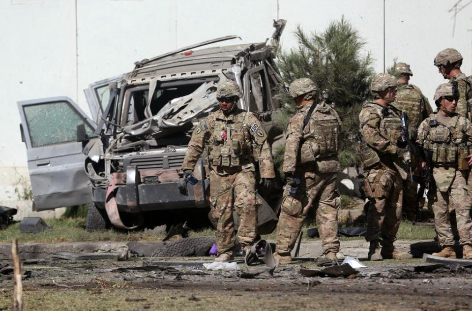 U.S. troops inspect the site of a suicide attack in Kabul, Afghanistan, in 2014. Some 2,400 U.S. servicemen and women have lost their lives during the 18-year U.S. presence in the region — the most recent in early September as the Taliban struck again and vowed to disrupt upcoming presidential elections.