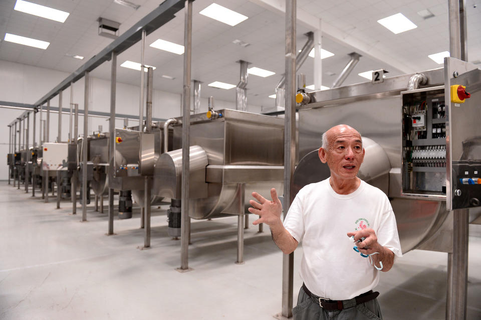 In this July 18, 2013 photo, David Tran, owner of Huy Fong Foods, maker of Sriracha hot sauce, shows his new $15 million, 650,000 square foot factory in Irwindale, Calif. The city of Irwindale on Monday, Oct. 28, 2013 filed a lawsuit in Los Angeles Superior Court asking a judge to stop production at the Huy Fong Foods factory, claiming the chili odor emanating from the plant is a public nuisance. (AP Photo/San Gabriel Valley Tribune, Sarah Reingewirtz) MAGS OUT; NO SALES; MANDATORY CREDIT