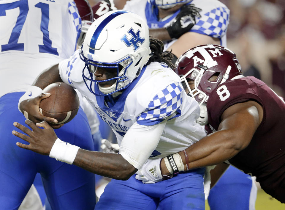 Kentucky quarterback Terry Wilson (3) is sacked by Texas A&M defensive lineman Kingsley Keke (8) during the second half of an NCAA college football game Saturday, Oct. 6, 2018, in College Station, Texas. (AP Photo/Michael Wyke)