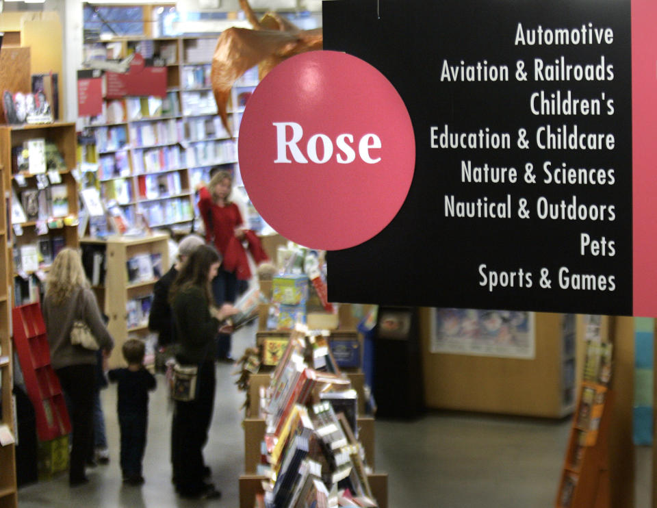 FILE - This Jan. 4, 2008 file photo shows people perusing books in the Rose Room at Powell's Bookstore in downtown Portland, Ore. A destination bookstore can make you feel like you're part of the community, whether you're grooving on the laidback vibe at Powell's or tuning into the Beltway buzz at Washington's Politics & Prose.(AP Photo/Don Ryan, file)