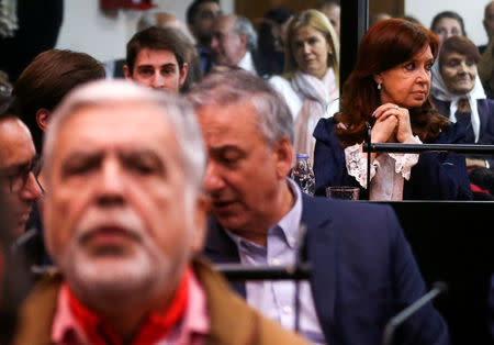 Former Argentine President Cristina Fernandez de Kirchner looks on behind Former Planning Minister Julio de Vido, in a court room before the start of a corruption trial, in Buenos Aires, Argentina May 21, 2019. REUTERS/Agustin Marcarian