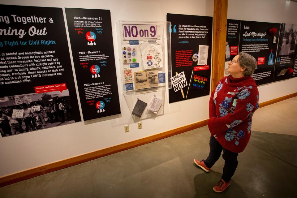 Lexie Briggs, marketing and communications specialist for the Museum of Natural and Cultural History, walks through the museum’s “Outliers and Outlaws—Stories from the Eugene Lesbian History Project" exhibit.