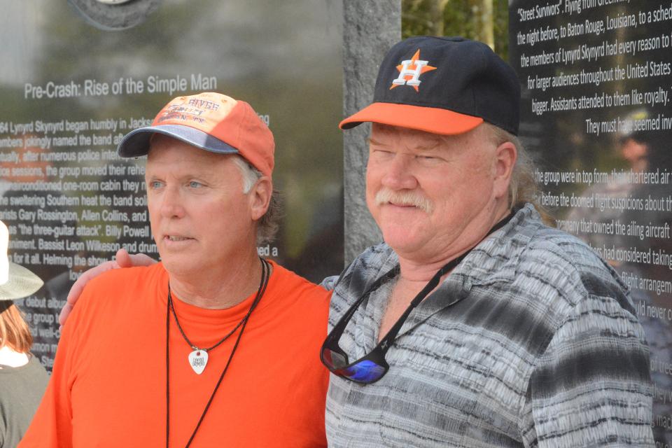 Lynyrd Skynyrd plane crash survivors Mark Howard, left, and Steve Lawler stand in front of a monument dedicated to those who died in the Oct. 20, 1977. The two were at the unveiling ceremony 42 years later, on Oct. 20, 2019.