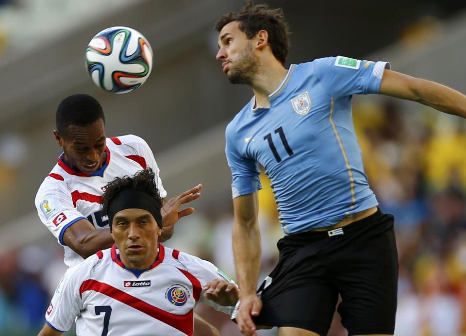 Costa Rica's Junior Diaz (L) and Christian Bolanos fight for the ball against Uruguay's Christian Stuani (R) during their 2014 World Cup Group D soccer match at the Castelao arena in Fortaleza June 14, 2014. (Marcelo Delpozo/Reuters)