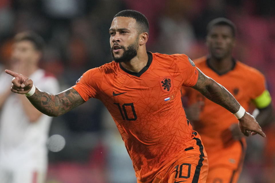 FILE - Memphis Depay of the Netherlands celebrates scoring his side's first goal during the World Cup 2022 group G qualifying soccer match between the Netherlands and Montenegro at the Philips stadium in Eindhoven, Netherlands, Saturday, Sept. 4, 2021. (AP Photo/Peter Dejong, File)