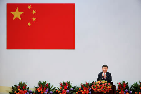 FILE PHOTO - Chinese President Xi Jinping applauds during the swearing in ceremony of the new Hong Kong government on the 20th anniversary of the city's handover from British to Chinese rule, in Hong Kong, China, July 1, 2017. REUTERS/Bobby Yip/File Photo