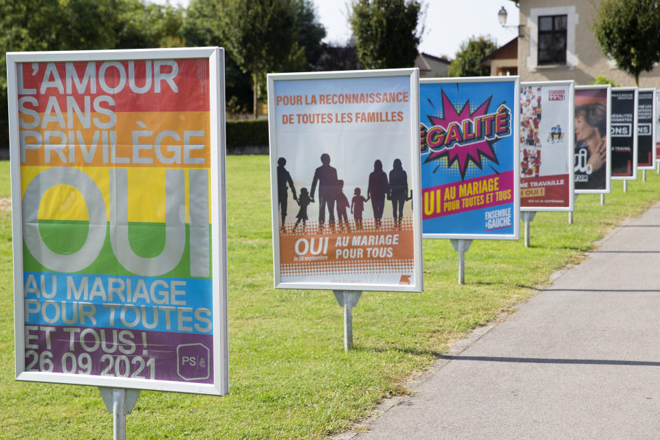 Posters of political parties and associations showing their slogans in Perly near Geneva, Saturday Sept. 25, 2021. Voters in Switzerland will decide Sunday whether to allow same-sex marriages in the rich Alpine country, one of the few in Western Europe where gay and lesbian couples do not already have the right to wed. Opponents have argued that replacing civil partnerships with full marriage rights somehow would undermine families based on a union between one man and one woman. (Salvatore Di Nolfi/Keystone via AP)