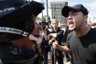 <p>White nationalists, neo-Nazis and members of the “alt-right” exchange insults with counter-protesters as they enter Lee Park during the “Unite the Right” rally August 12, 2017 in Charlottesville, Virginia. After clashes with anti-fascist protesters and police the rally was declared an unlawful gathering and people were forced out of Lee Park, where a statue of Confederate General Robert E. Lee is slated to be removed. (Photo: Chip Somodevilla/Getty Images) </p>