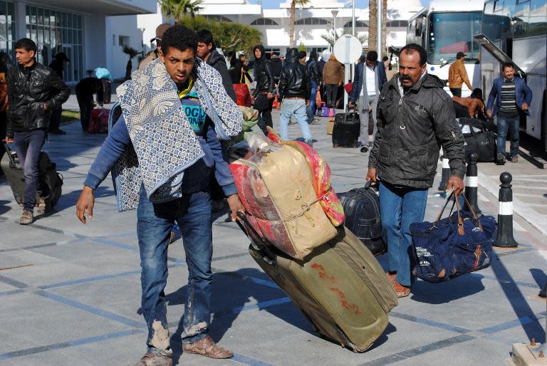 Egyptians, who were formerly residing in Libya, arrive at Djerba airport on the Tunisian-Libyan border, for a flight evacuating them to Cairo, on February 23, 2015