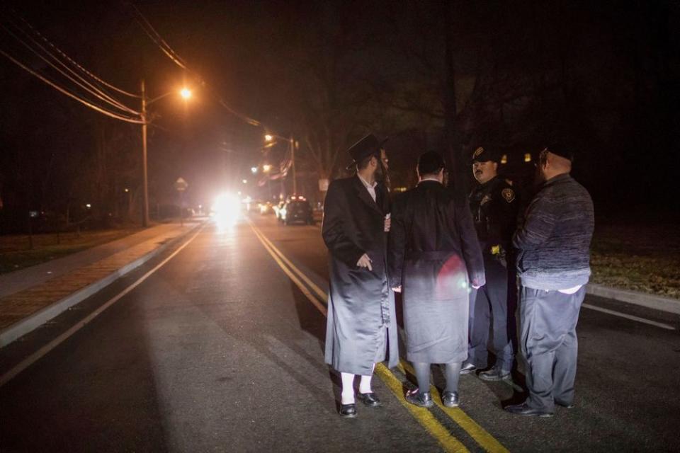 Witnesses talk to police after the stabbing at a rabbi's house in Monsey, New York | Allyse Pulliam/AP/Shutterstock