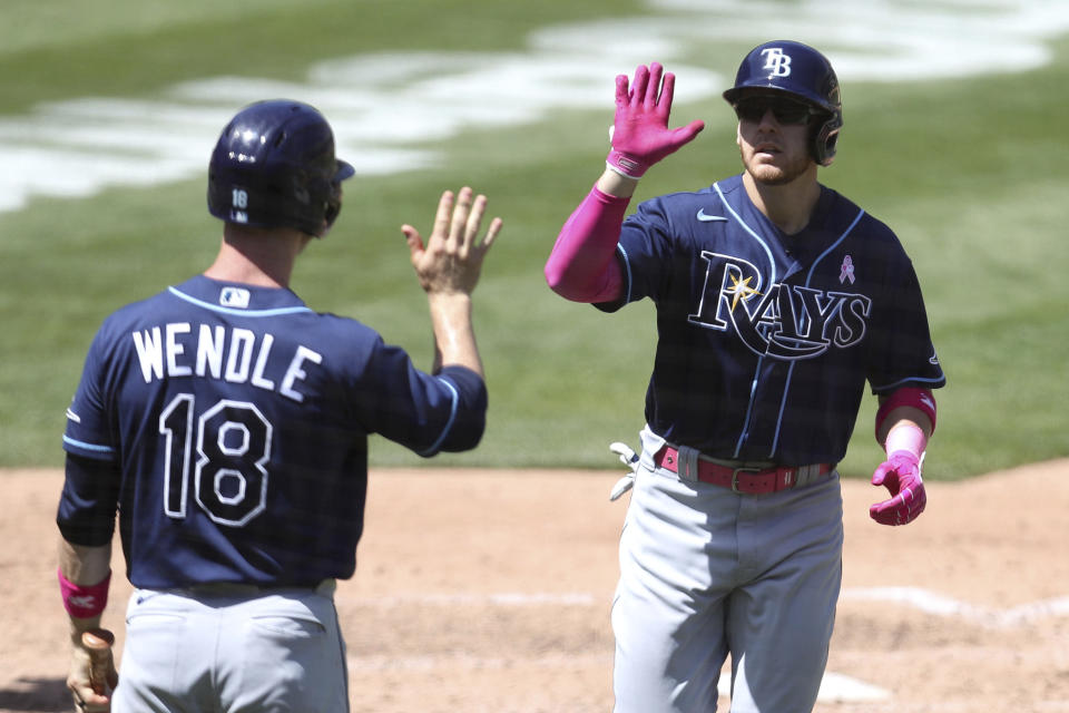 Tampa Bay Rays' Mike Brosseau, right, is congratulated by teammate Joey Wendle after hitting a solo home run against the Oakland Athletics during the sixth inning of a baseball game in Oakland, Calif., Sunday, May 9, 2021. (AP Photo/Jed Jacobsohn)