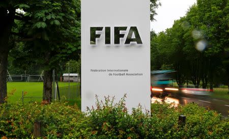 Cars drive past a logo in front of FIFA's headquarters in Zurich, Switzerland June 8, 2016. REUTERS/Arnd Wiegmann/Files