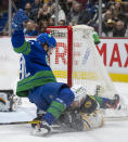 Vancouver Canucks right wing Vasily Podkolzin (92) gets tangles up with Boston Bruins defenseman Connor Clifton (75) during the second period of an NHL hockey game Wednesday, Dec. 8, 2021 in Vancouver, British, Columbia. (Jonathan Hayward/The Canadian Press via AP)