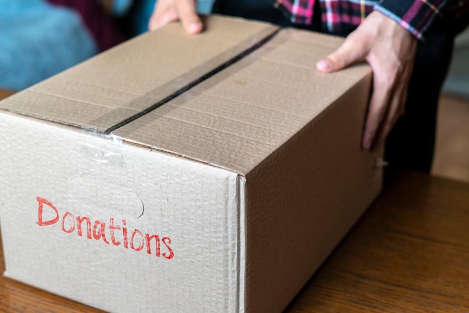 Person holding taped cardboard box with 