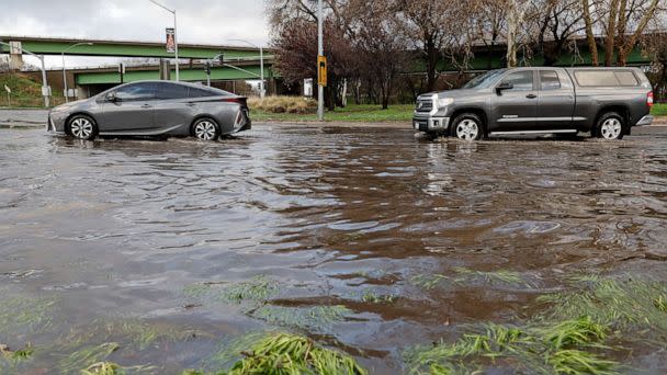 PHOTO: Drivers navigate a flooded street after winter storms brought high winds and heavy rain in Sacramento, California, Jan. 8, 2023. (Fred Greaves/Reuters)