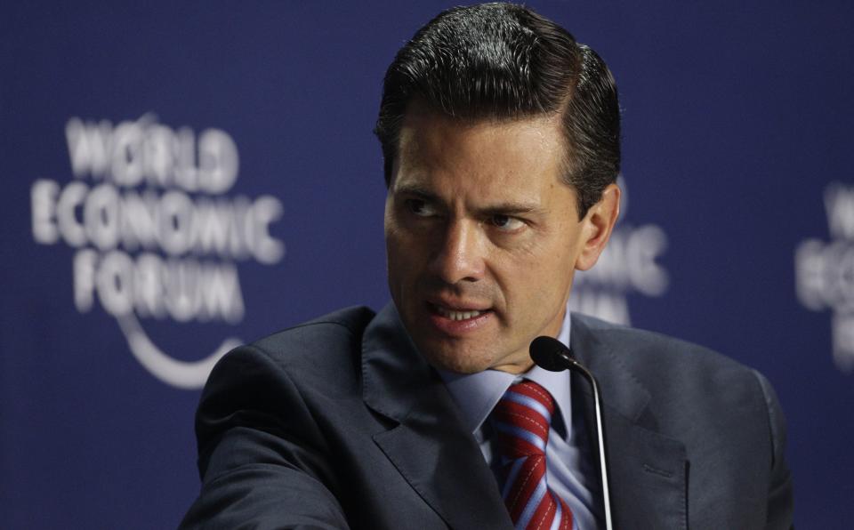 Mexico's President Enrique Pena Nieto, right, speaks during the last day of the World Economic Forum on Latin America in Panama City, Thursday, April 3, 2014. (AP Photo/Arnulfo Franco)